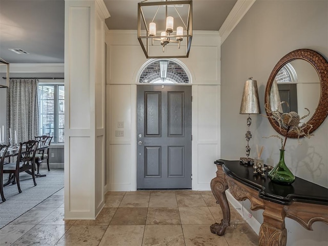 foyer entrance featuring an inviting chandelier, crown molding, light tile patterned flooring, and visible vents