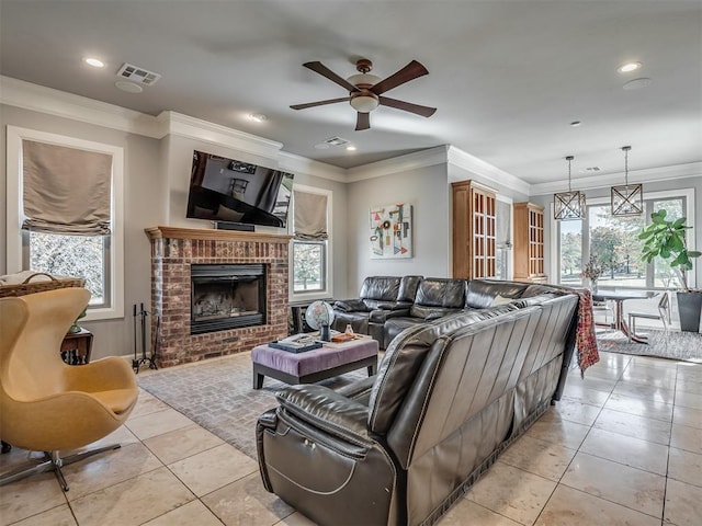 living room featuring visible vents, crown molding, light tile patterned floors, recessed lighting, and a fireplace