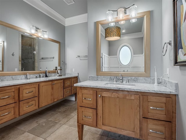 full bathroom with a tile shower, ornamental molding, two vanities, and a sink