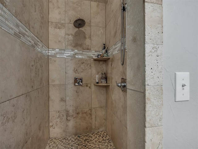 interior details featuring a tile shower