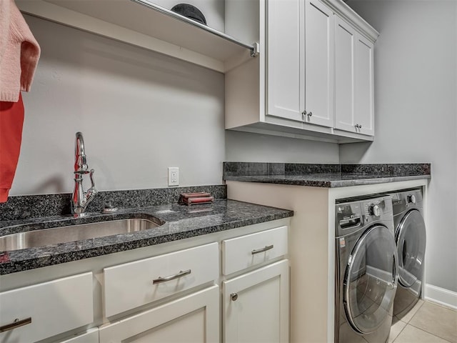 laundry area with a sink, cabinet space, light tile patterned flooring, and washer and dryer