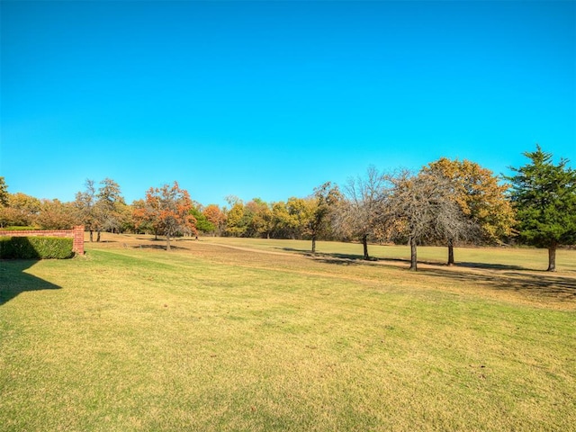 view of property's community with a lawn and a rural view