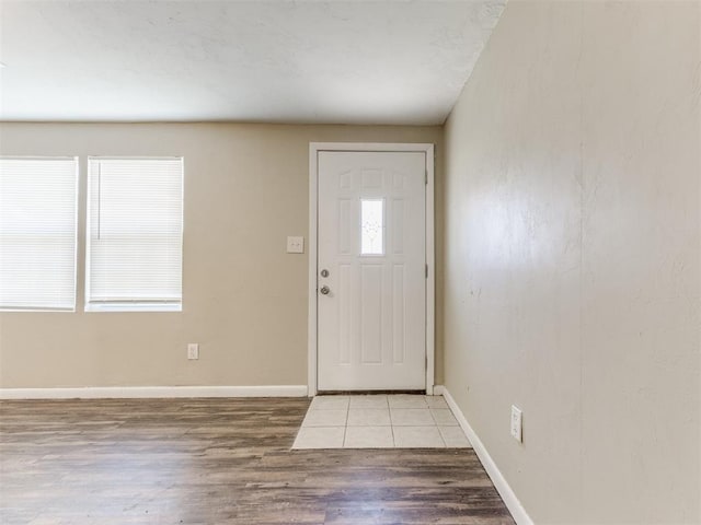 entrance foyer featuring baseboards and wood finished floors