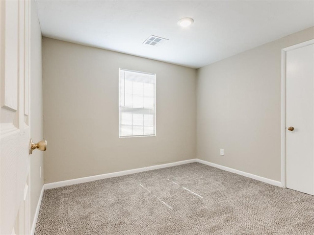 unfurnished room featuring visible vents, baseboards, and carpet