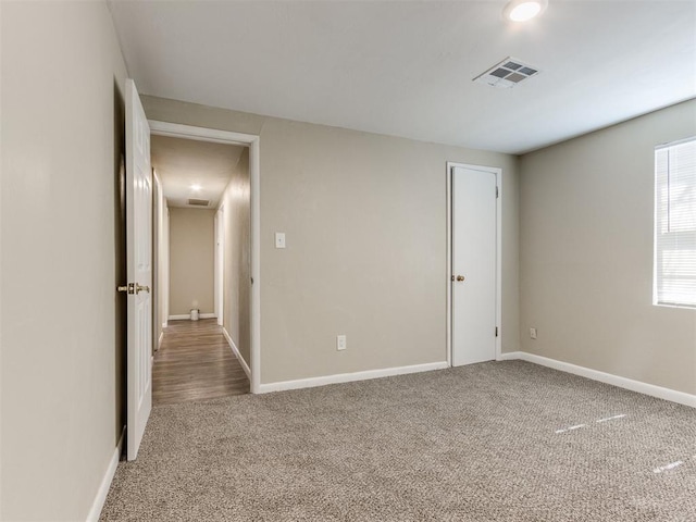 unfurnished bedroom with visible vents, baseboards, and carpet flooring