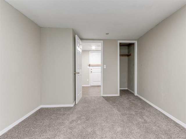 unfurnished bedroom featuring a closet, baseboards, and carpet