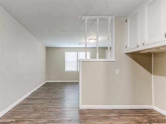 interior space with visible vents, baseboards, and dark wood-type flooring