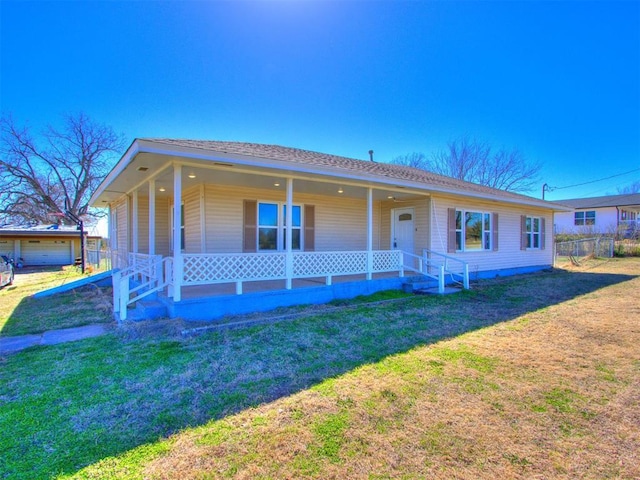 view of front of house featuring a porch, a front yard, and fence