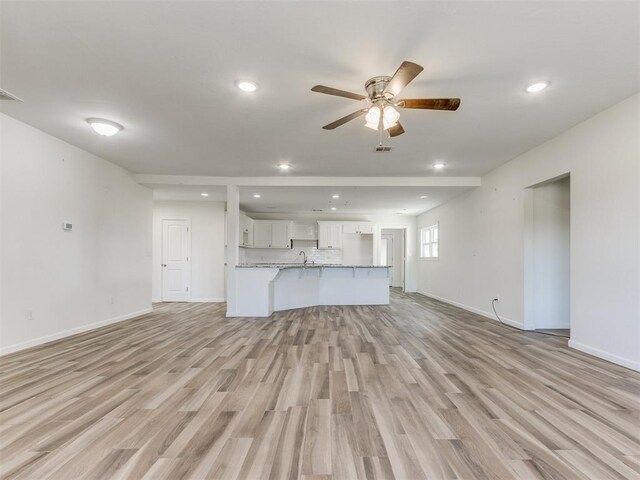 37005 Lake Rd, Shawnee, OK 74801 - unfurnished living room with ceiling fan, light wood finished floors, recessed lighting, baseboards, and visible vents