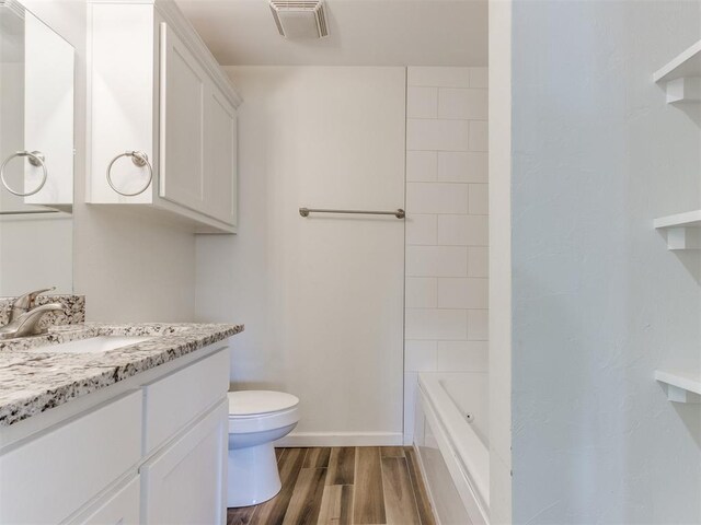37005 Lake Rd, Shawnee, OK 74801 - full bath featuring vanity, toilet, baseboards, wood finished floors, and visible vents