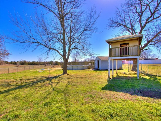 37005 Lake Rd, Shawnee, OK 74801 - view of yard featuring a storage unit, a fenced backyard, an outbuilding, and a fenced in pool