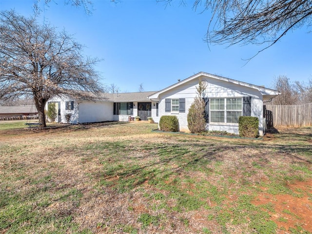 single story home with a front lawn and fence