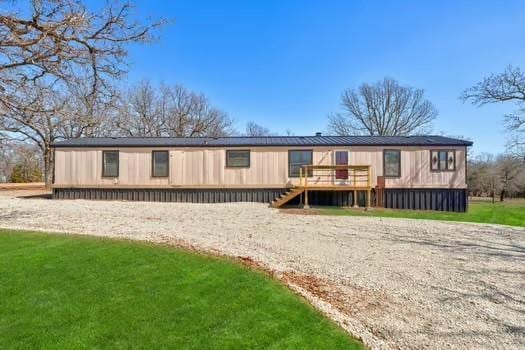 back of property featuring a wooden deck