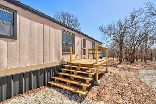 view of home's exterior with a wooden deck