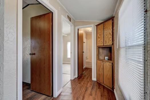 hall featuring visible vents and wood finished floors