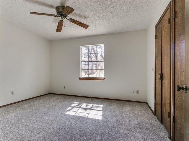 2000 N Alexander Ln, Bethany, OK 73008 - unfurnished bedroom with carpet flooring, a textured ceiling, and ceiling fan