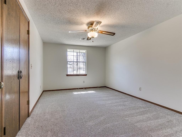 2000 N Alexander Ln, Bethany, OK 73008 - spare room with light carpet, ceiling fan, and a textured ceiling