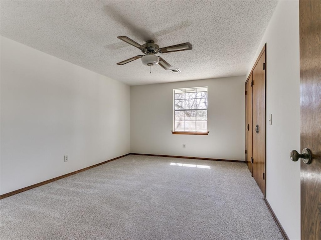 2000 N Alexander Ln, Bethany, OK 73008 - unfurnished bedroom featuring light carpet, a textured ceiling, and a ceiling fan