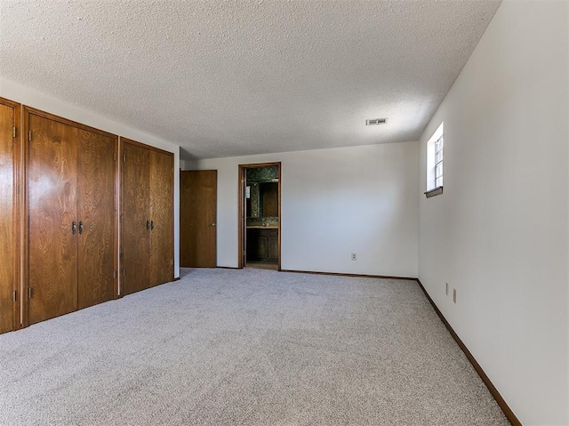 2000 N Alexander Ln, Bethany, OK 73008 - unfurnished bedroom with light carpet and a textured ceiling