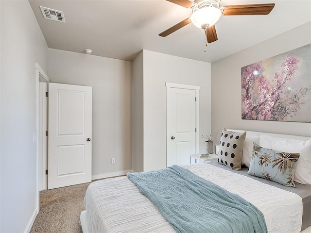 bedroom featuring ceiling fan, carpet floors, visible vents, and baseboards