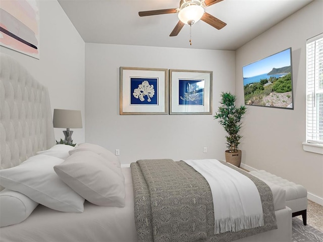 bedroom with carpet floors, ceiling fan, and baseboards