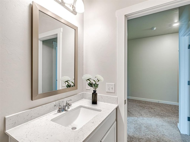 bathroom featuring baseboards and vanity