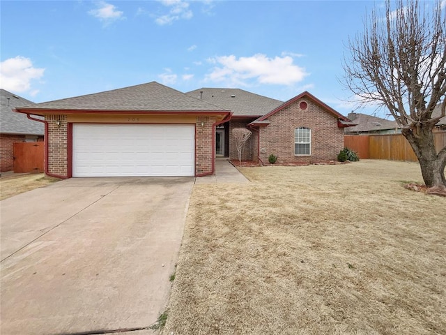 ranch-style house with a garage, brick siding, driveway, and fence