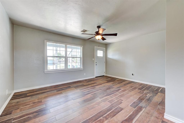 2625 SW 46th St, Oklahoma City, OK 73119 - unfurnished room with wood finished floors, a ceiling fan, and baseboards