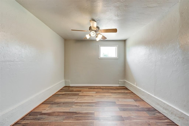 2625 SW 46th St, Oklahoma City, OK 73119 - unfurnished room featuring a ceiling fan, a textured wall, wood finished floors, and baseboards