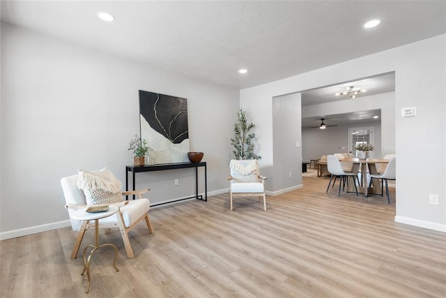 living area featuring recessed lighting, wood finished floors, and baseboards