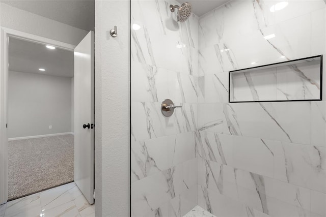 bathroom with a tile shower