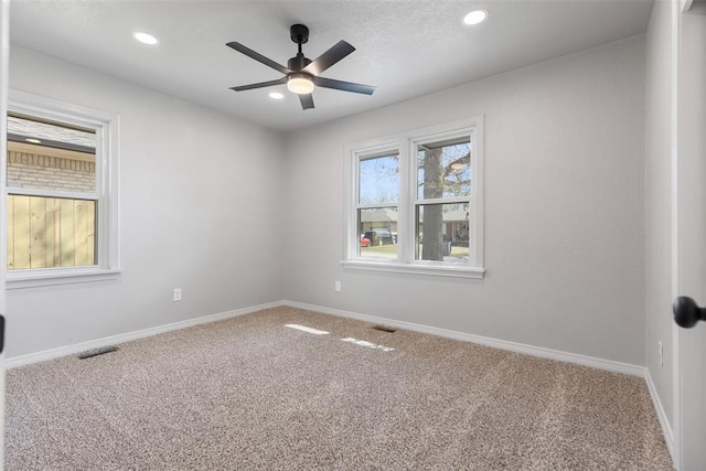 carpeted spare room with recessed lighting, visible vents, baseboards, and ceiling fan