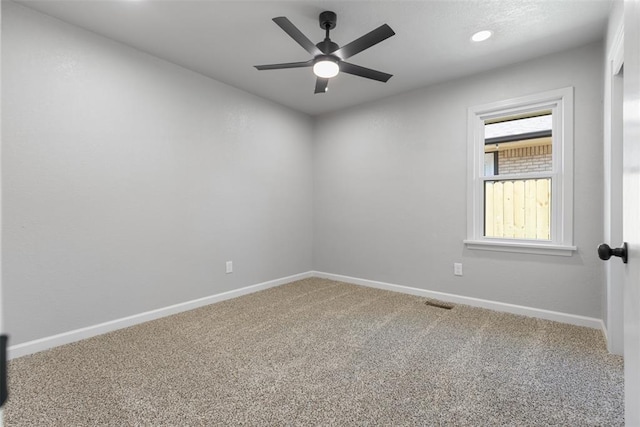 empty room featuring baseboards, carpet floors, and a ceiling fan