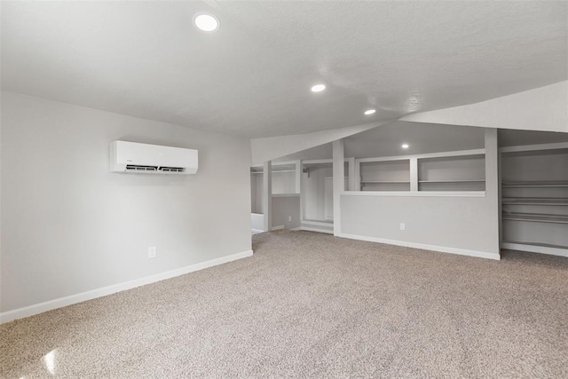 interior space with carpet, a wall unit AC, recessed lighting, and baseboards