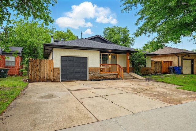 1731 Carlisle Rd, The Village, OK 73120 - single story home featuring an attached garage, fence, brick siding, and stone siding