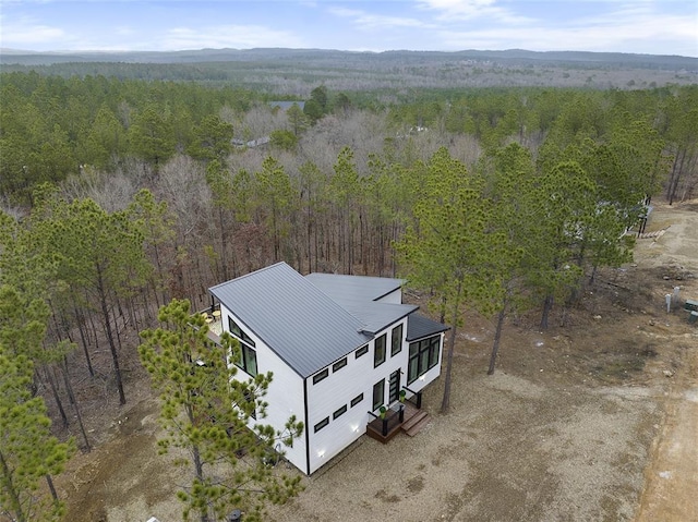 bird's eye view with a wooded view