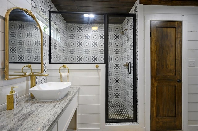 full bathroom with a stall shower and vanity