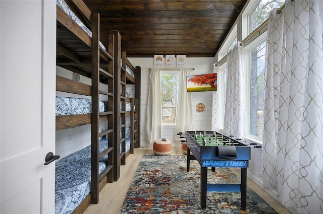 game room with lofted ceiling, wooden ceiling, and light wood finished floors