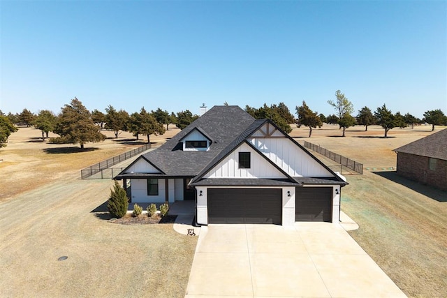 modern farmhouse with fence, roof with shingles, concrete driveway, an attached garage, and a front yard