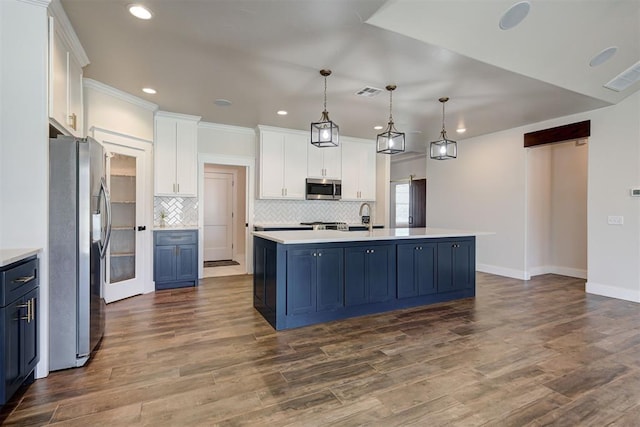 kitchen with blue cabinetry, stainless steel appliances, white cabinets, and light countertops