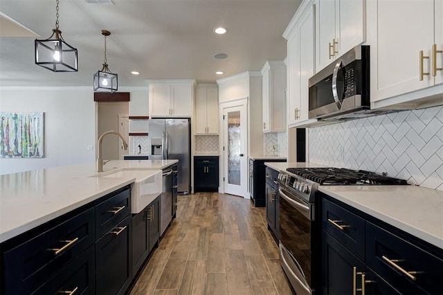 kitchen with stainless steel appliances, white cabinets, crown molding, light countertops, and dark wood-style flooring