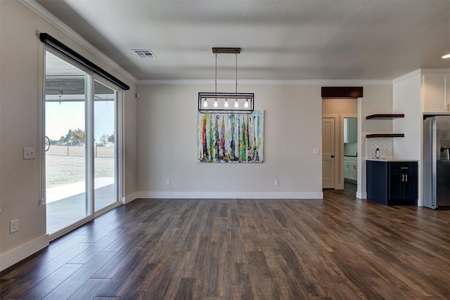 unfurnished living room with dark wood finished floors, visible vents, baseboards, and ornamental molding