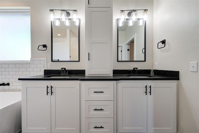 bathroom with a sink, a tub, and double vanity