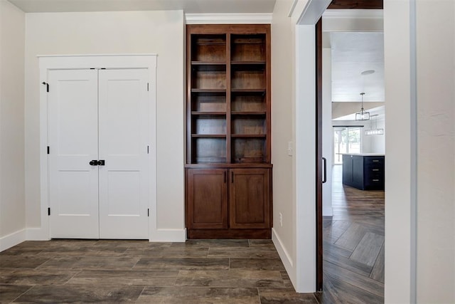 interior space featuring parquet flooring and baseboards