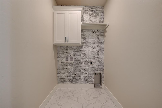 clothes washing area featuring washer hookup, cabinet space, baseboards, and electric dryer hookup