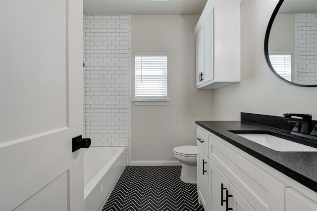 bathroom with baseboards, toilet, and vanity