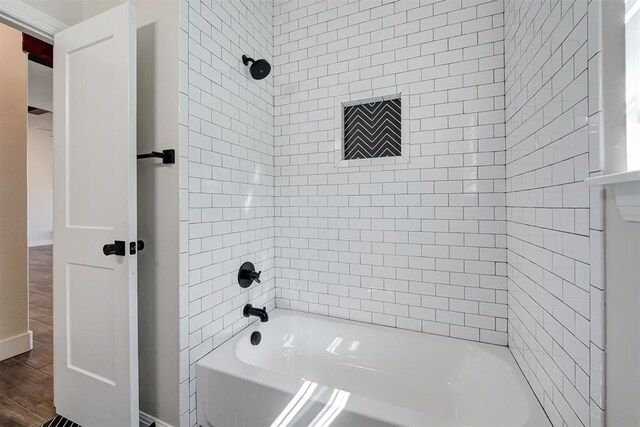 bathroom featuring  shower combination and wood finished floors