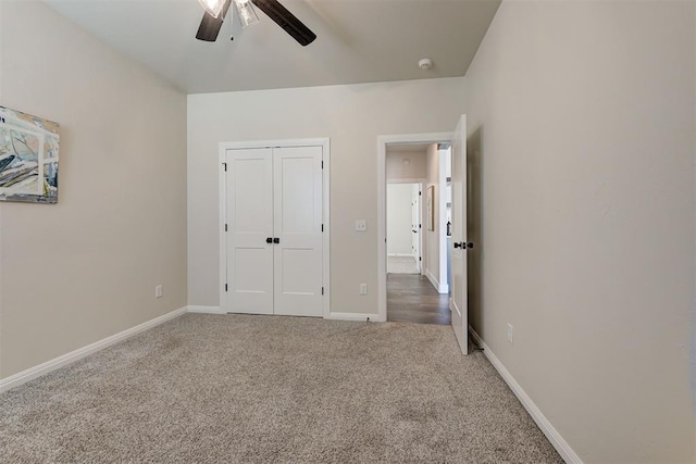 unfurnished bedroom with a closet, ceiling fan, baseboards, and carpet floors