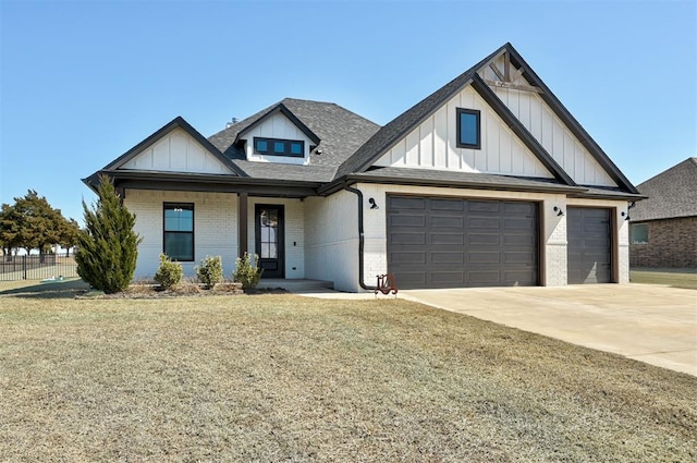 modern farmhouse featuring brick siding, board and batten siding, a shingled roof, a front lawn, and concrete driveway