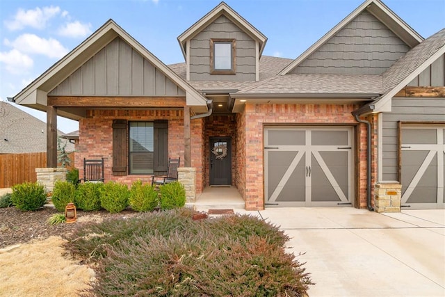 craftsman-style house with concrete driveway, a garage, covered porch, and a shingled roof